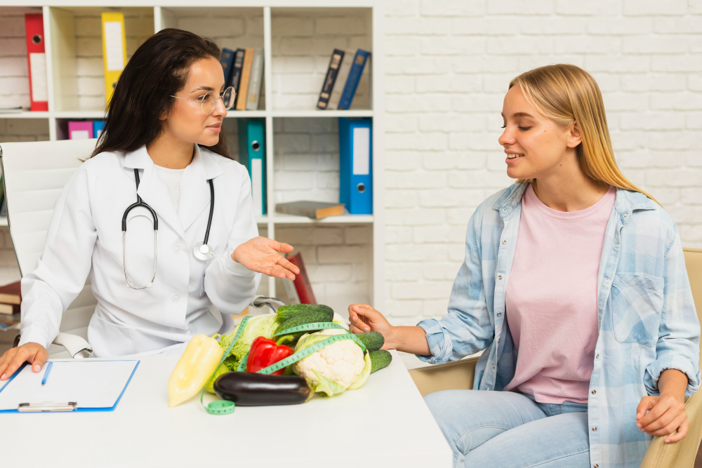 Nutritionist talking to patient about vegetables.